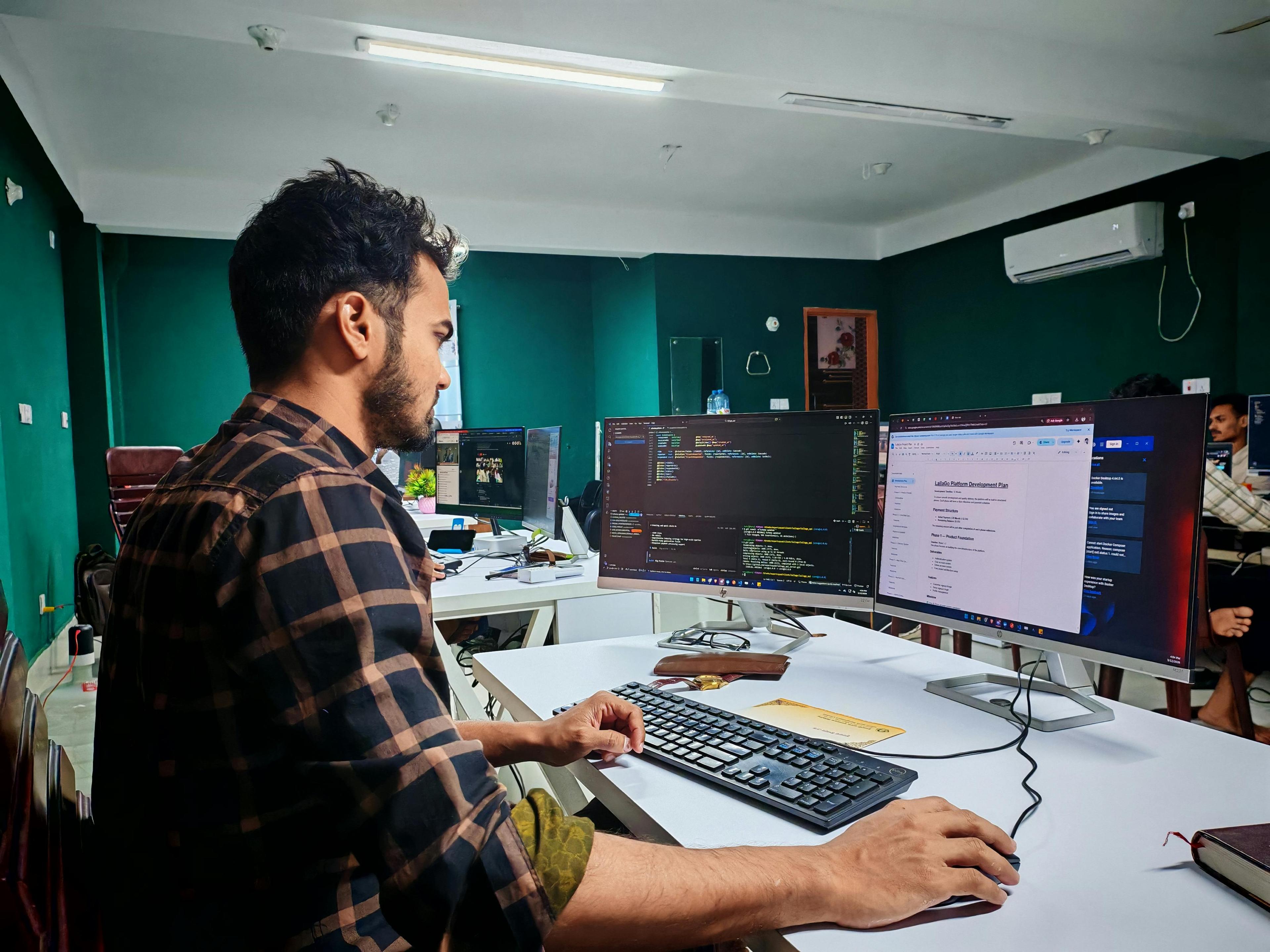 Focused developer writing code at a standing desk