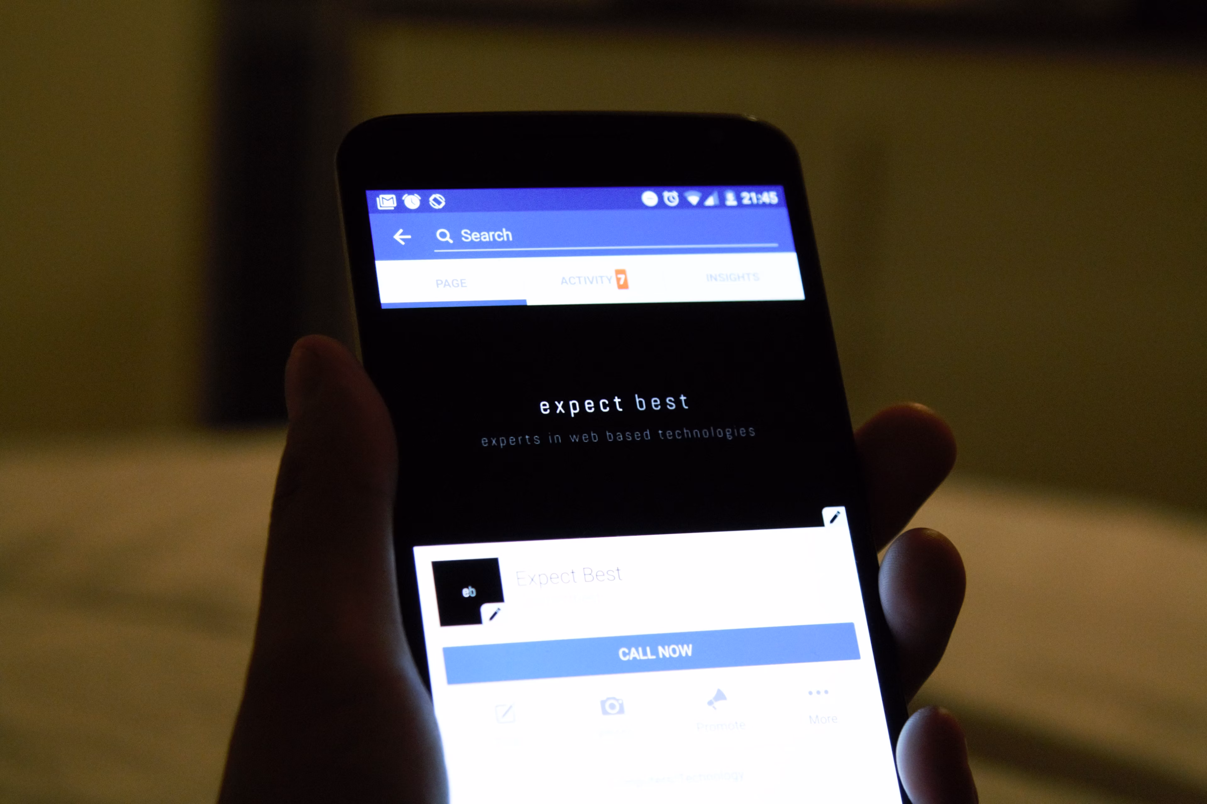 Close-up of a hand holding a smartphone showing a social media application