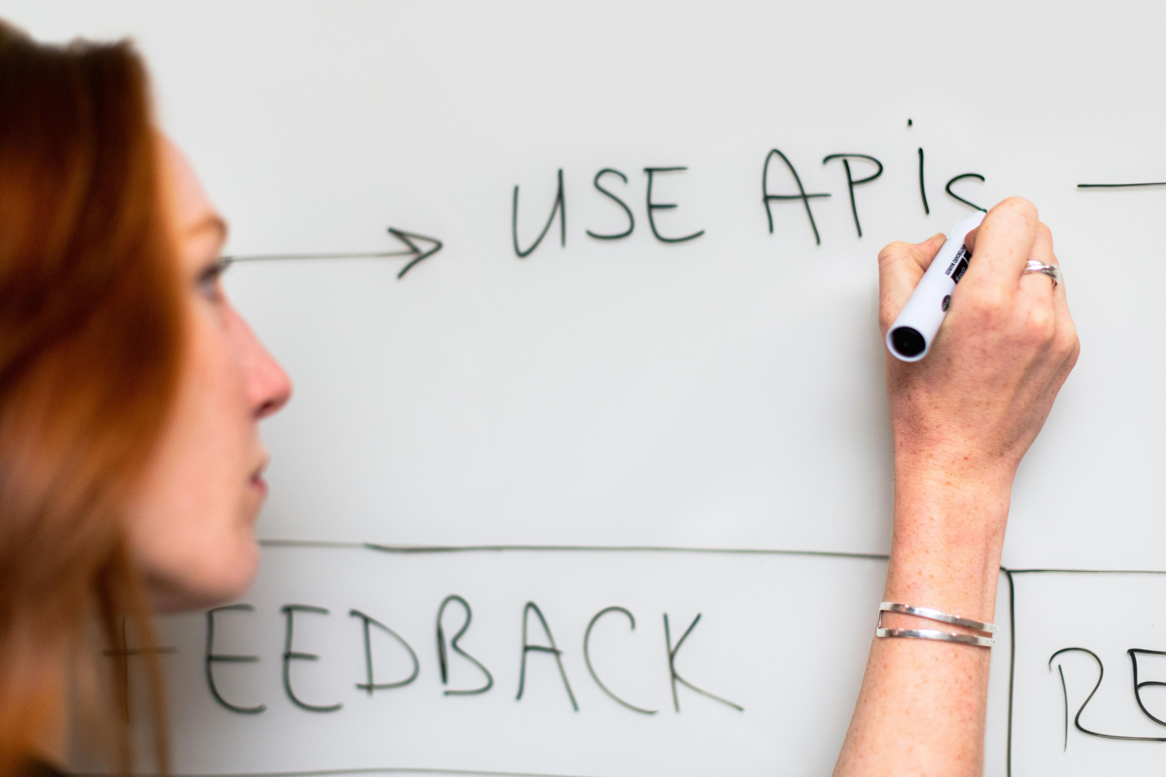 Two engineers reviewing design work together in front of a monitor