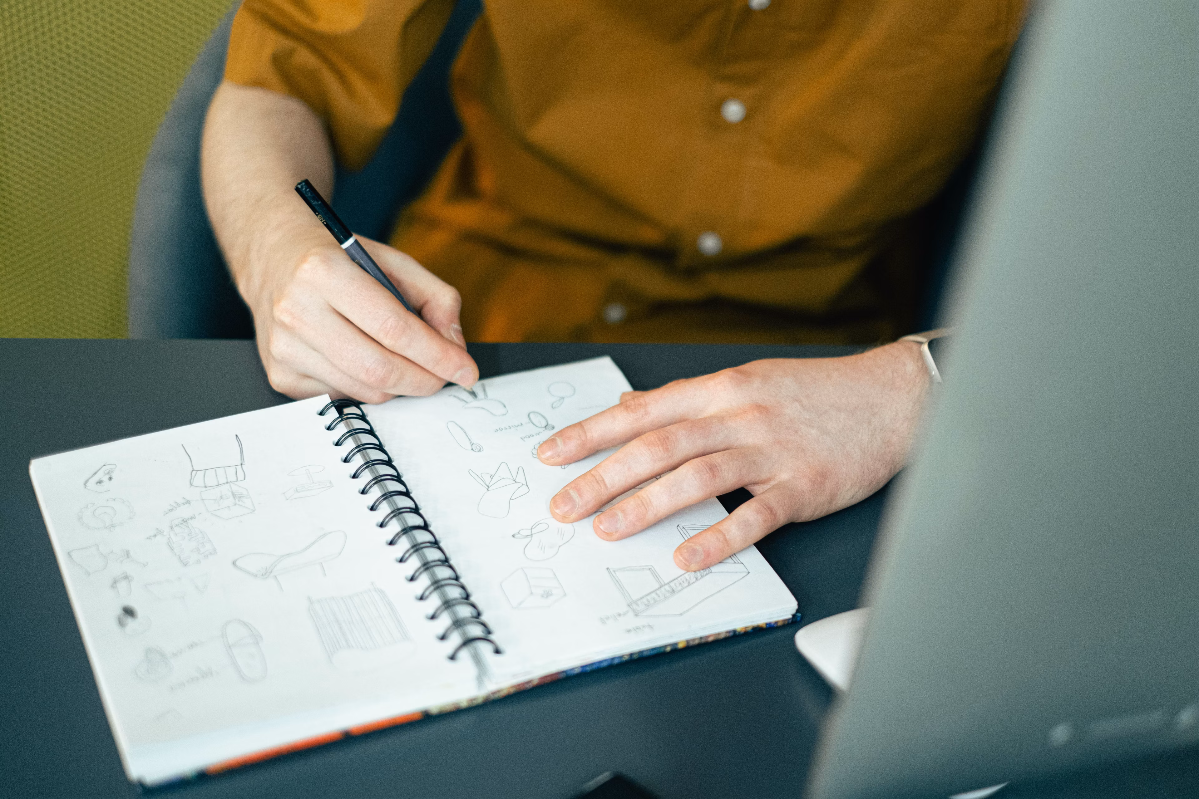 Creative workspace with colorful sticky notes and sketchbooks on a bright desk