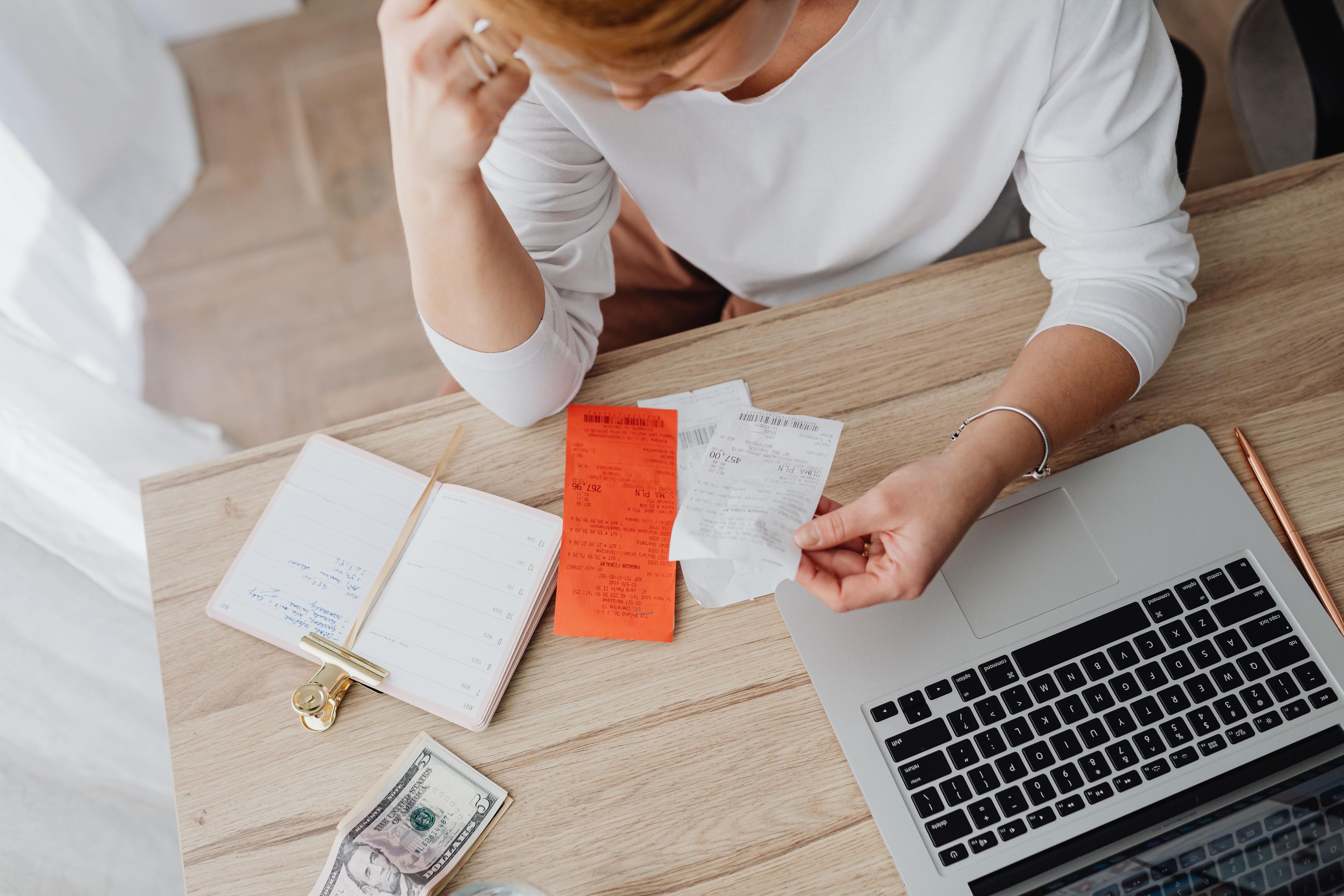 Woman reviewing receipts and finances at her desk
