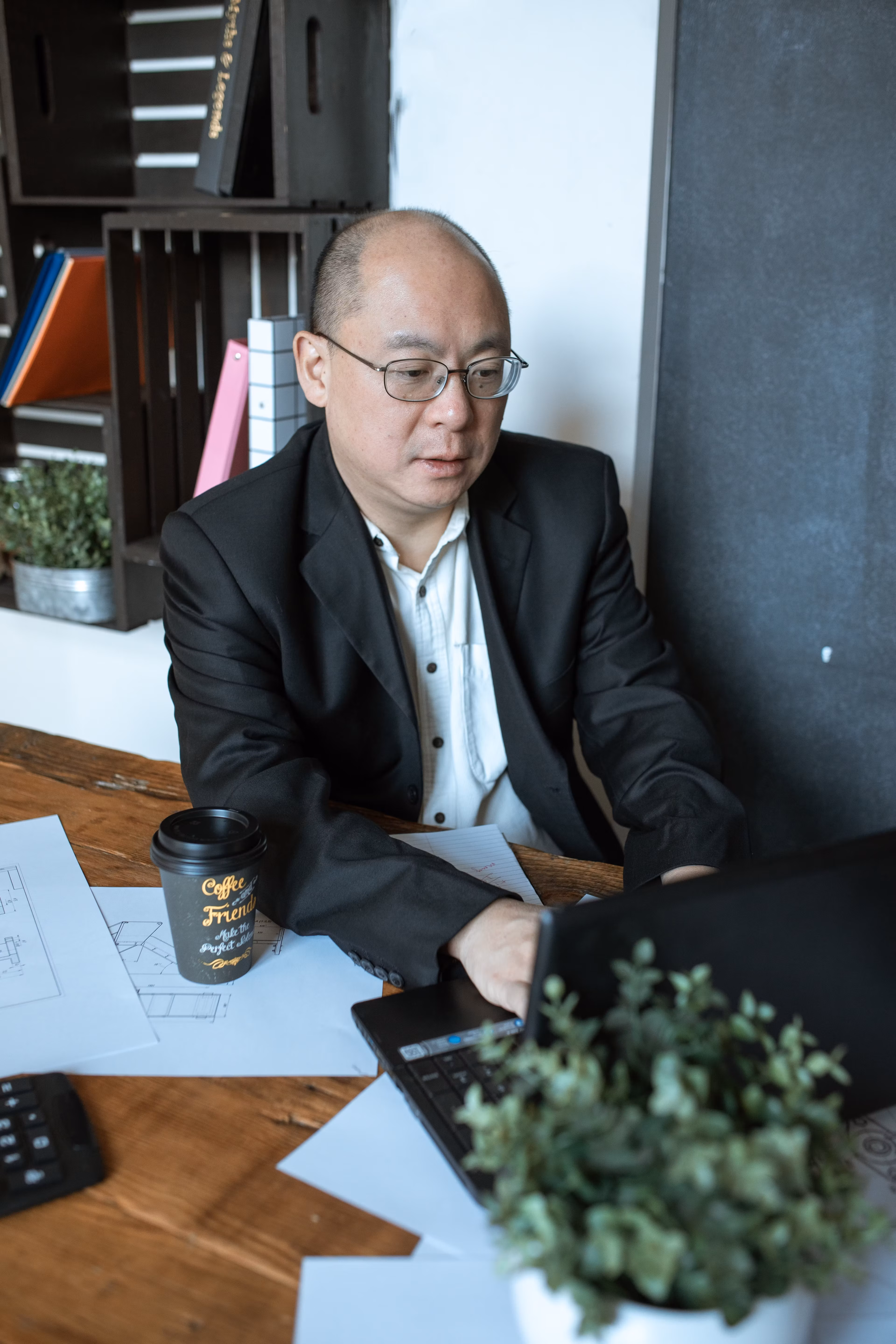 Businessman working intently on laptop at his desk in an office